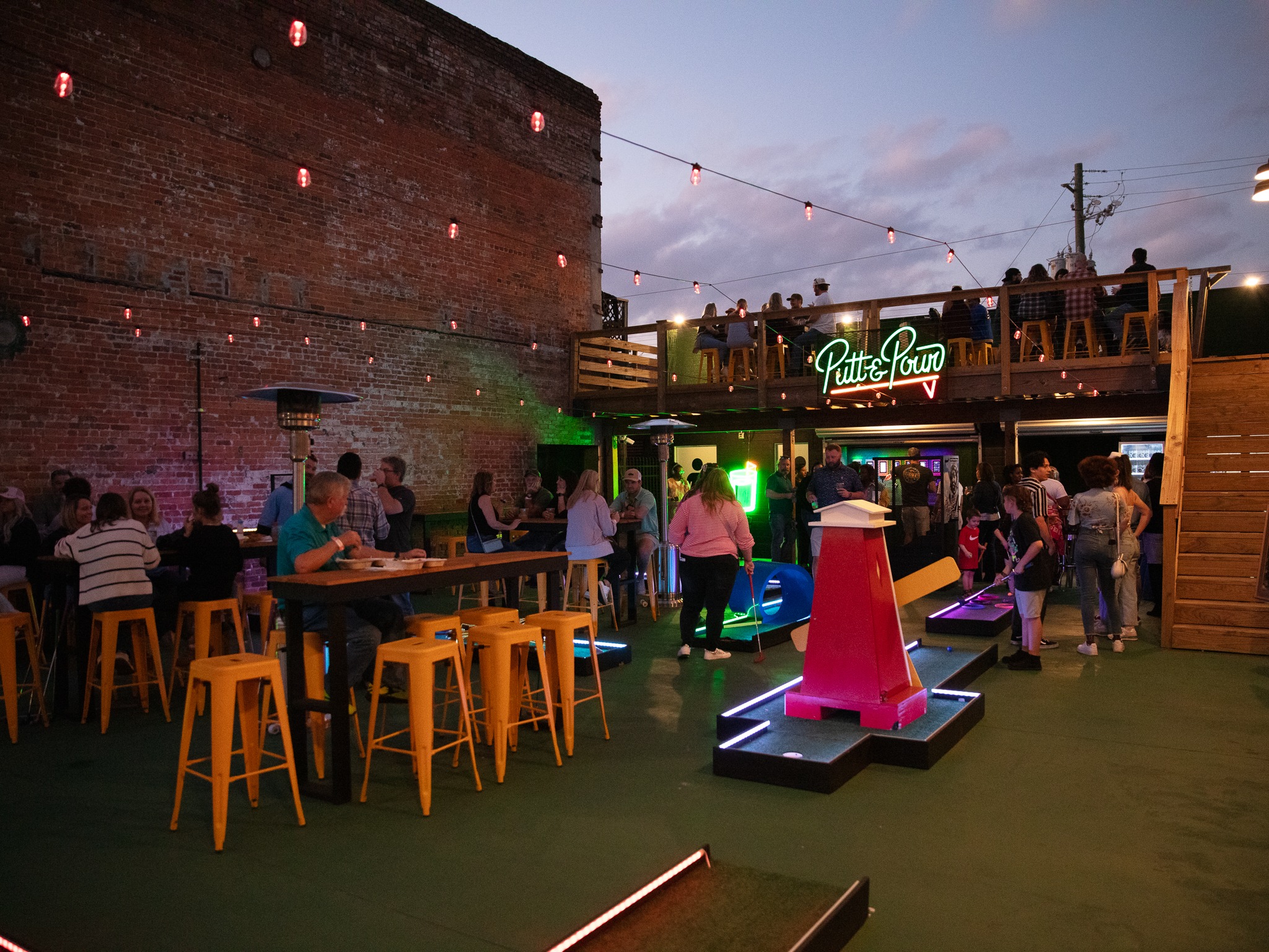 Guests enjoying the Putt and Pour courtyard