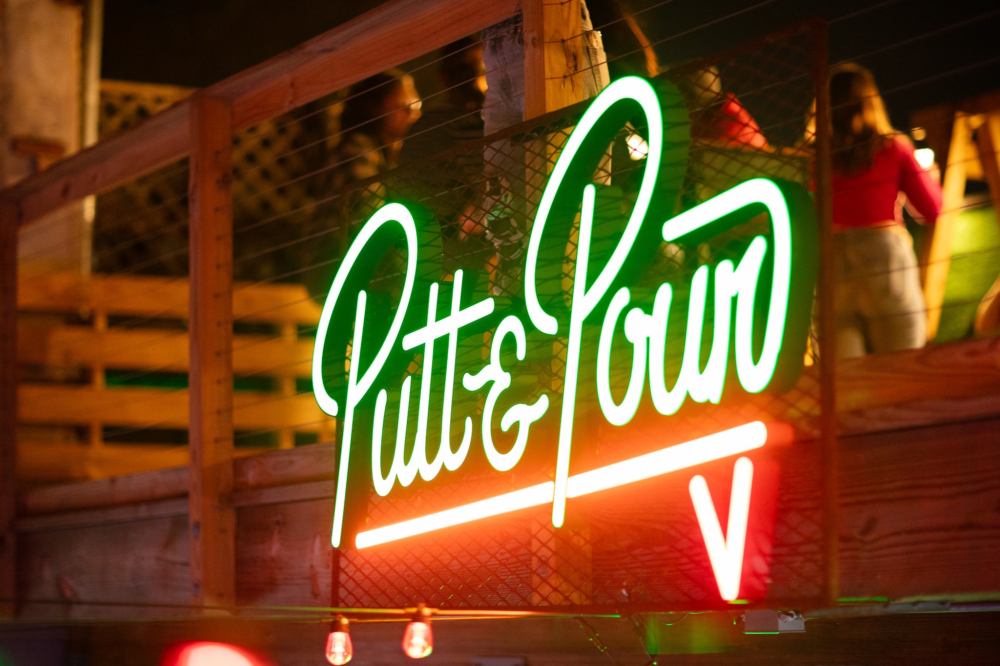 Putt and Pour neon sign glowing at night